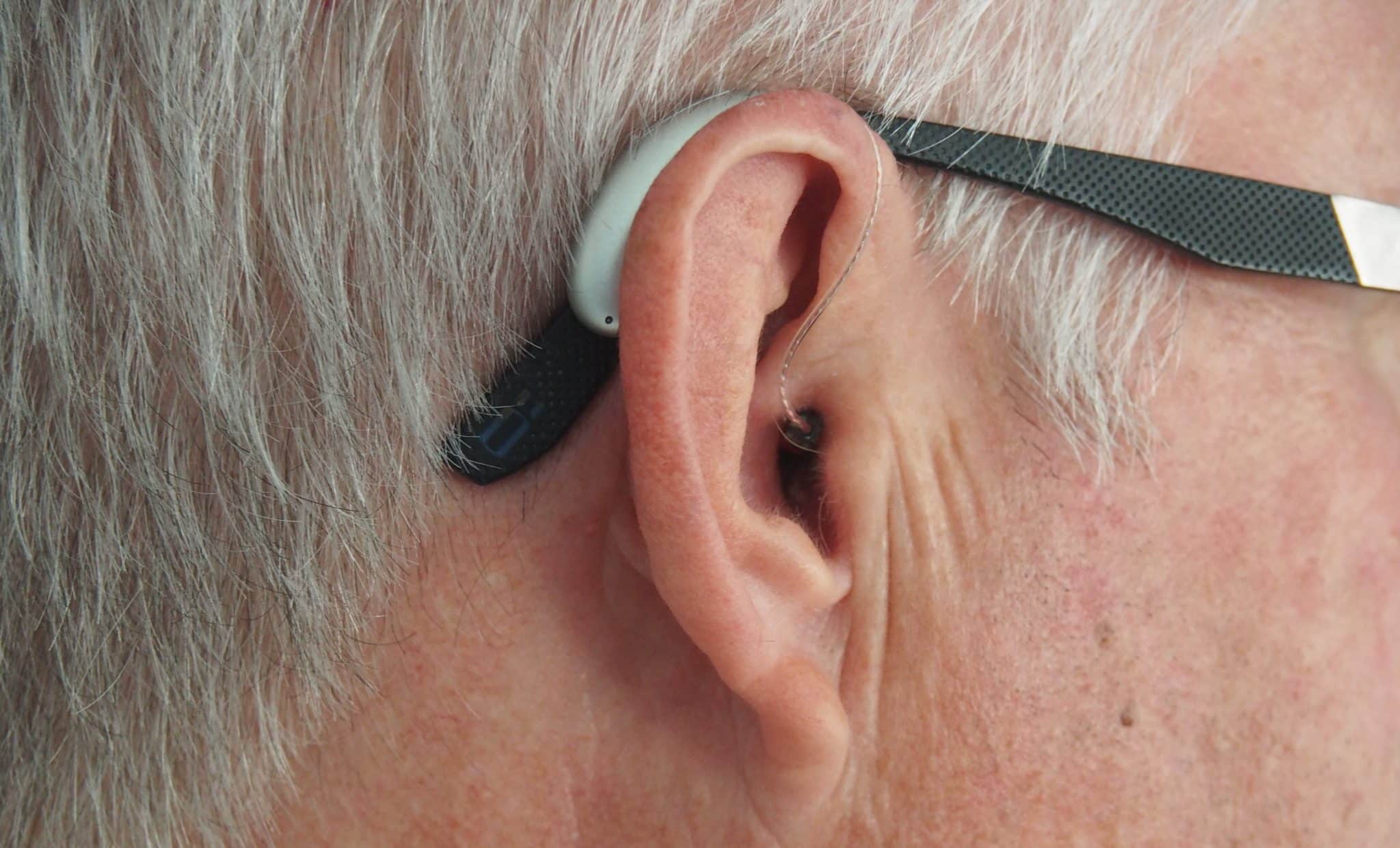 older gentleman with glasses wearing hearing aids