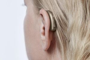 A hearing aid on a woman's ear