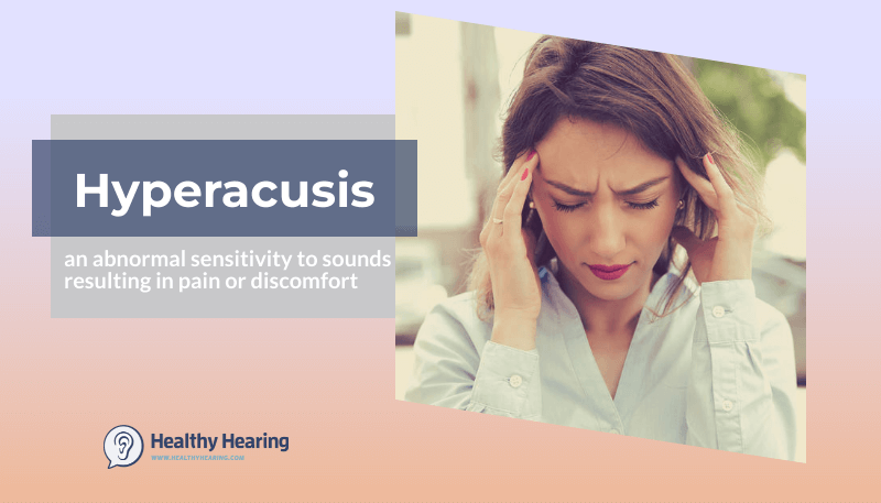 A woman grips her forehead, suffering from hyperacusis, or noise-induced pain.