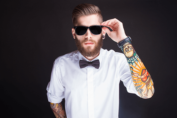 Man with sunglasses and tattoo sleeves