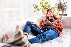 A woman uses brainwave entrainment to relax.