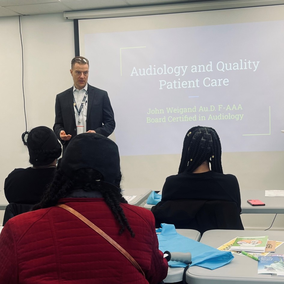 Audiologist John P. Weigand giving speech