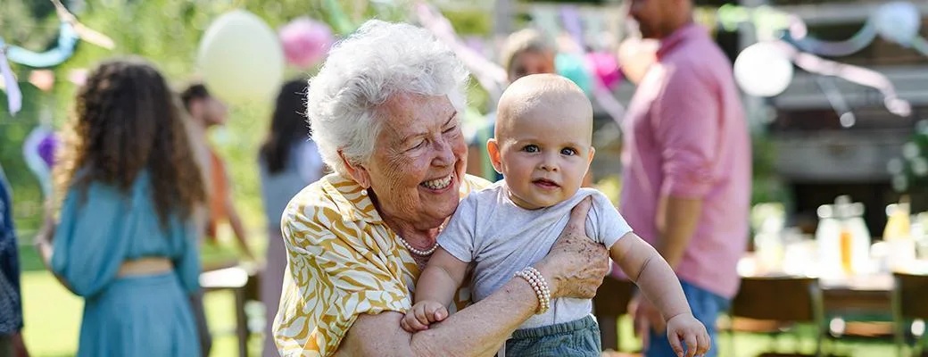 Image of grandmother holding a baby grandchild