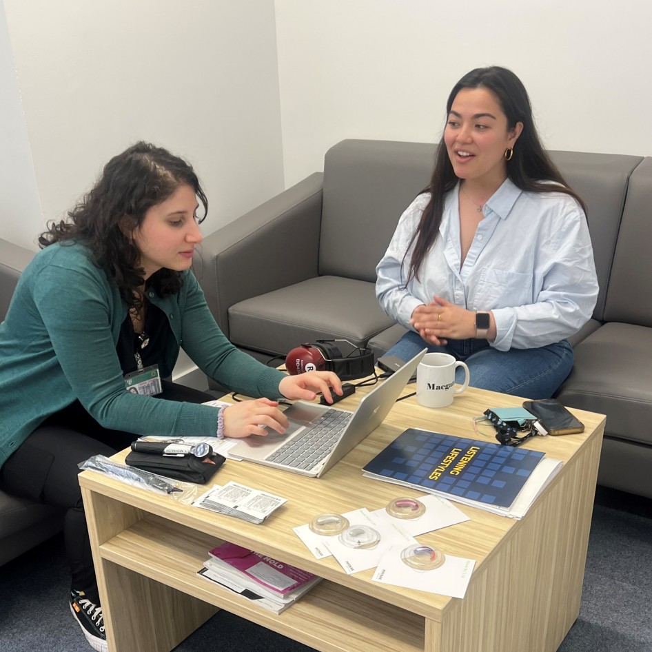 Audiologist Ruth Reisman typing on laptop next to patient