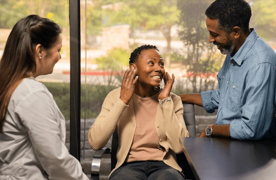 A woman gets new hearing aids.