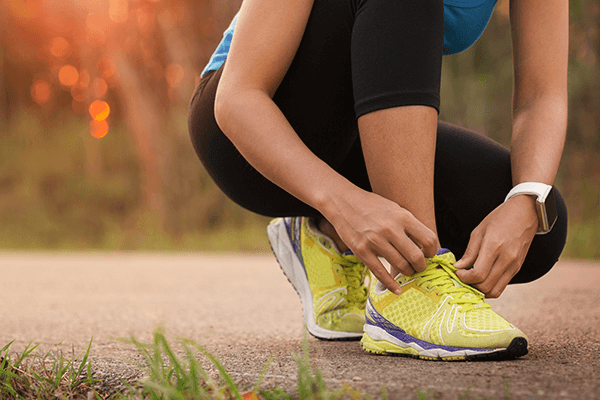 Woman running with smart watch
