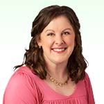 Erica Pidor, hearing care specialist wearing a pink top and a gold necklace.