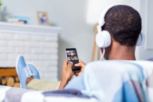 A man wears headphones while doing sound therapy.