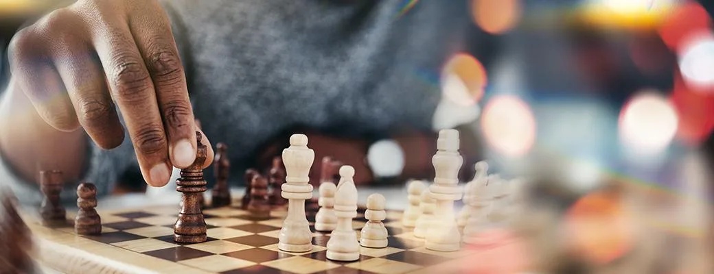 Image of hands playing chess