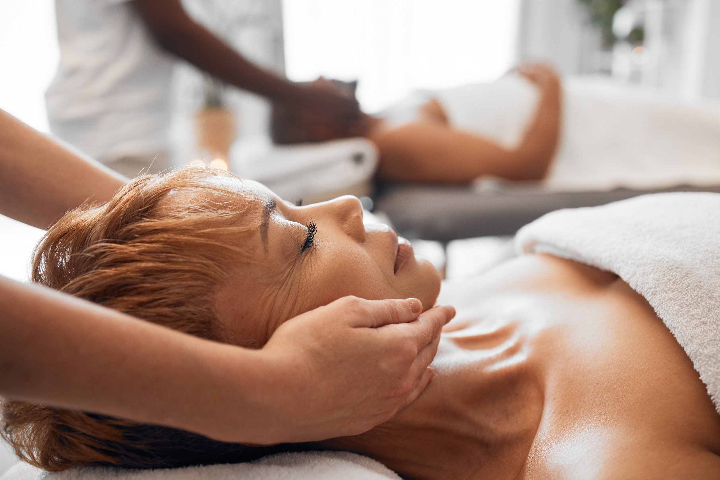 A woman receives a head and neck massage.