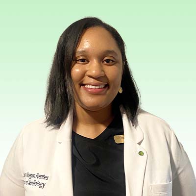 Ashley Morgan Fuentes, Doctor of Audiology, wearing a white coat against a green gradient background.
