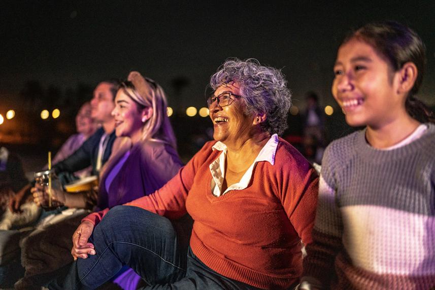 A group of people sitting outside at a concert
